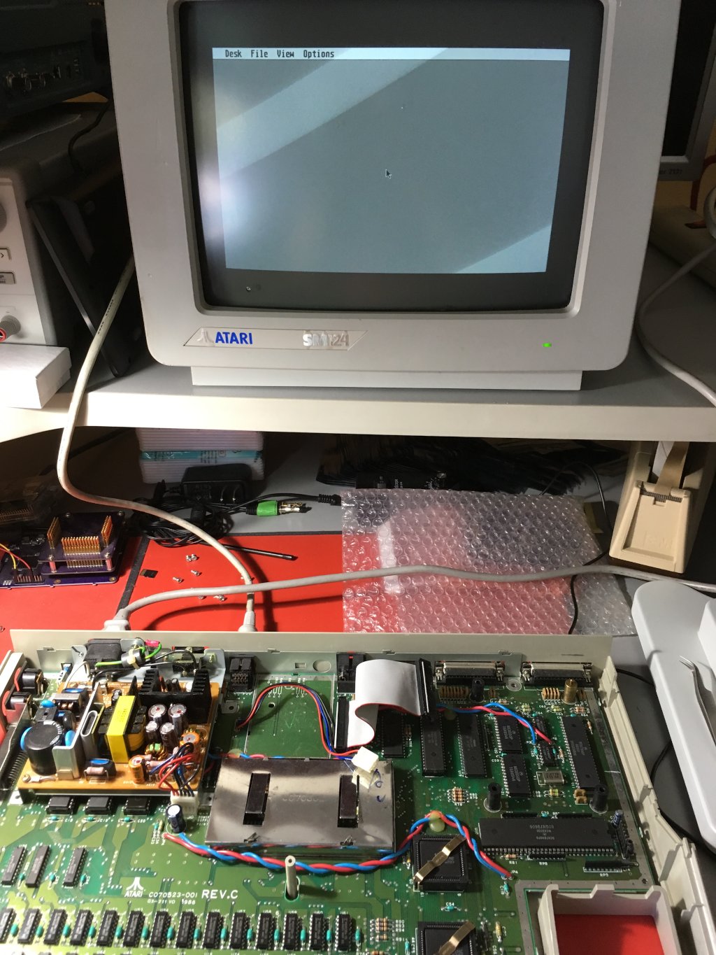 Atari ST 1040STF with case open, running, with desktop on monochrome CRT monitor